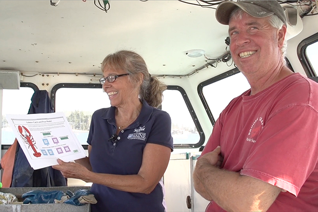 Esperanza Stancioff and lobsterman Dave Cousens standing inside his boat