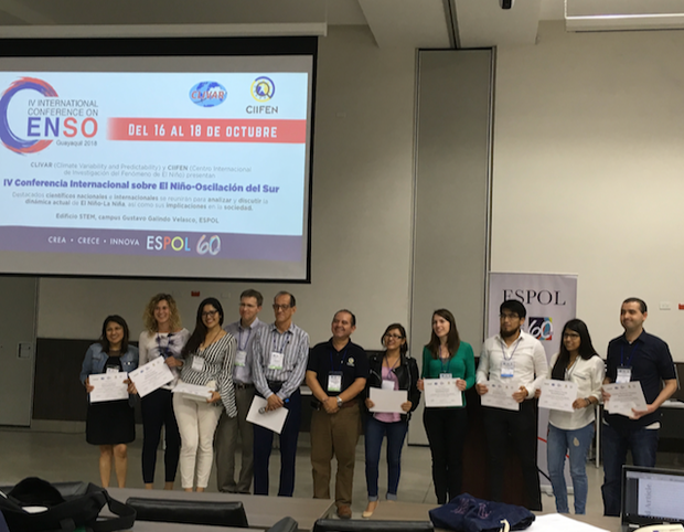 winners of the poster competition standing in front of audience